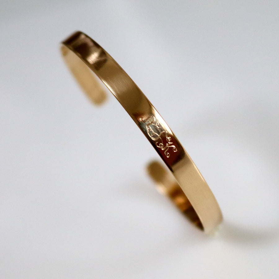 Narrow gold bangle with monogram initials